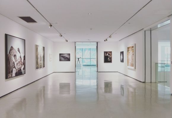 Floor - assorted paintings on white painted wall