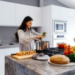 Kitchen Gadget - woman smiling while cooking
