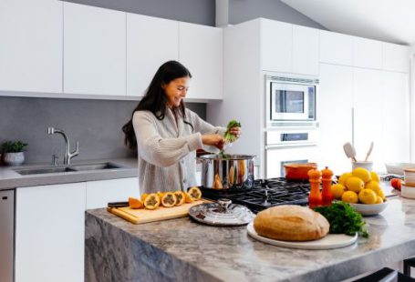 Kitchen Gadget - woman smiling while cooking